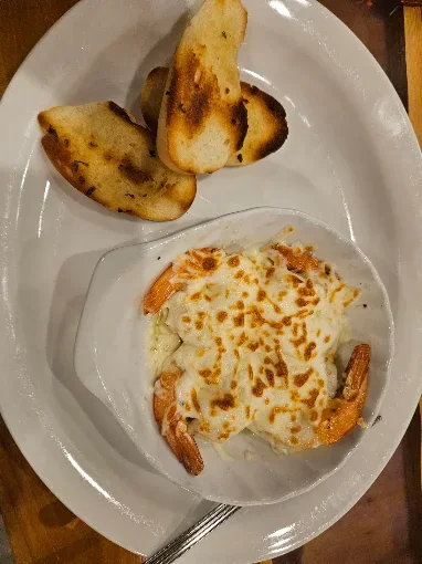 Baked cheesy appetizer with toasted bread at The Fed Downtown