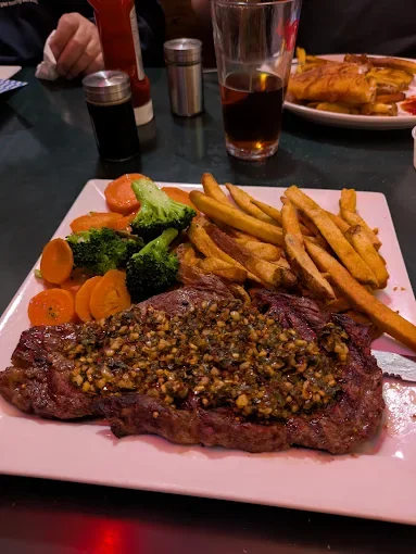 Steak dinner with fries and vegetables at The Fed Downtown