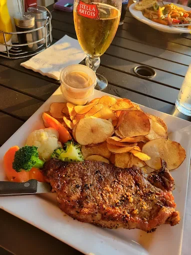 Grilled steak with vegetable sides and potato chips at The Fed Downtown